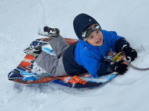 student snow sledding