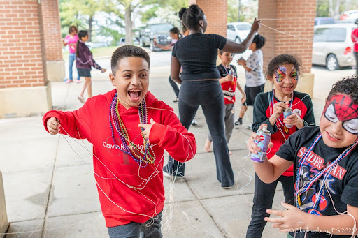 students celebrating outside of school